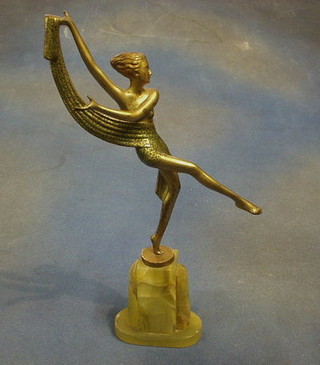 An Art Deco painted spelter figure of a dancing lady raised on a green onyx base 14"