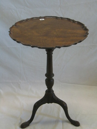 A circular Georgian mahogany bird cage table with pie crust border, raised on gun barrel turned column and carved tripod supports 20"