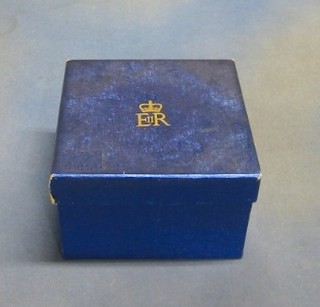 A square cardboard box covered in garter blue paper and having Elizabeth II Royal Cypher 7 1/2"