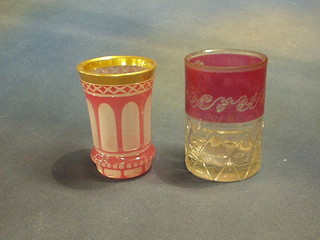 A Bohemian cut glass goblet engraved with an E, 4 1/2" and a Bohemian opaque and gilt banded glass 4 1/2"