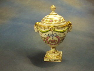 A Dresden porcelain urn and cover with floral decoration, rams head handles, raised on a square base, the base incised 297, 8" (finial f and r)