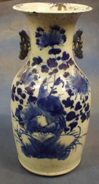 A 19th Century Oriental blue and white porcelain twin handled vase, decorated birds amidst flowering branches 16"