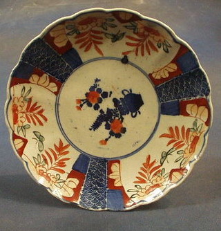 3 19th Century Japanese Imari porcelain plates with lobed and panelled bodies, the centre decorated a vase of flowers 8"