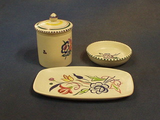 A 1960's circular Poole Pottery preserve jar and cover with rubber stamp mark, a rectangular pin tray 7" and a circular dish 4" (3)