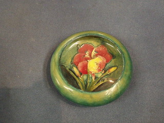 A Moorcroft Hibiscus pattern circular bowl, the base with signature mark, impressed Potter to HM The Queen 5"