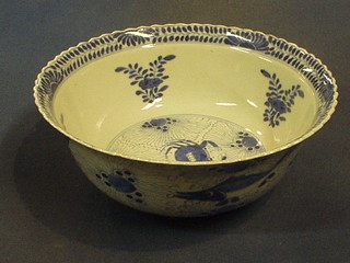 A 19th Century Oriental blue and white circular bowl, the interior decorated a crab, the exterior decorated fish, the base with 4 character mark 9" (cracked)