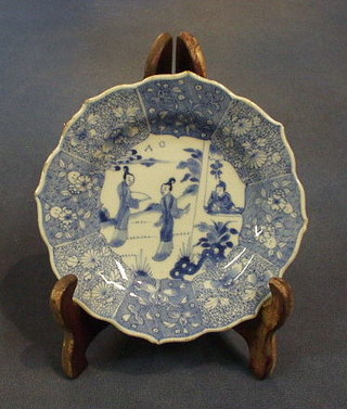 A pair of 18th/19th Century circular shaped Oriental blue and white porcelain saucers with wavy borders decorated figures 6"