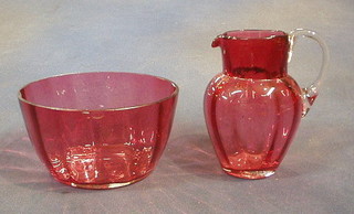 A 19th Century cranberry glass jug with clear glass handle, 5" and a cranberry glass bowl 5" (chipped)