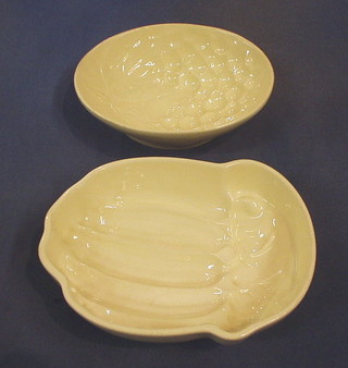 An oval grape decorated white glazed jelly mould 8 1/2"  and a shaped jelly mould 9" (unmarked)