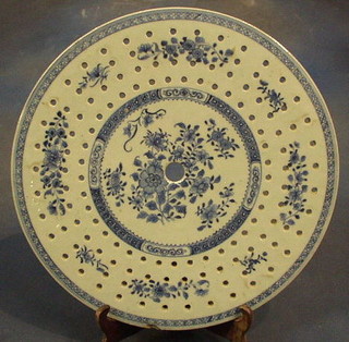 A 19th Century Oriental blue and white pierced circular straining platter with floral decoration 14" (chip to side)