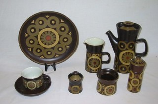 A 21 piece Denby Arabesque pattern coffee service comprising coffee pot, cream jug, pepper pot, mustard pot, circular storage pot 3" (no lid), 4 cups (1 cracked), 3 saucers, 4 10" dinner plates (1 cracked), 5 7" tea plates