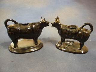 A pair of 19th Century black glazed Staffordshire cow creamers 6"