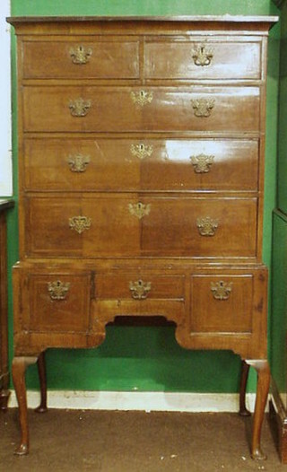 A Queen Anne chest on stand with moulded cornice, the upper section fitted 2 short and 3 long drawers, the base fitted 1 long drawer flanked by 2 short drawers, raised on cabriole supports (rear cabriole support f and w) 39"