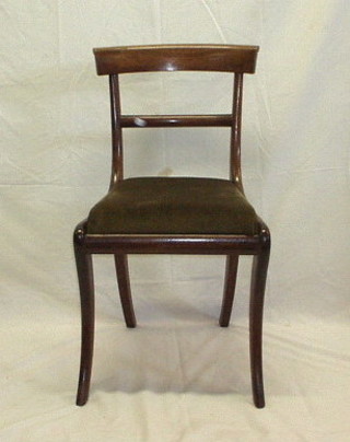 A set of 4 Georgian mahogany bar back dining chairs with plain mid rails, on sabre supports,