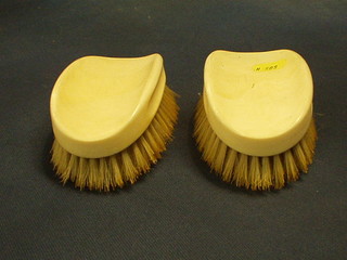 A pair of ivory backed military hair brushes