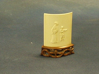 A miniature Oriental concave carved ivory table screen, 2" on a pierced hardwood stand