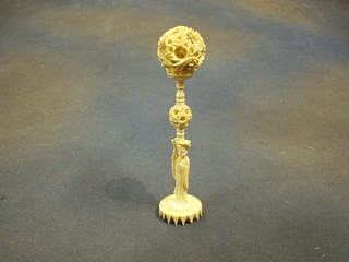 A pierced ivory puzzle ball and stand