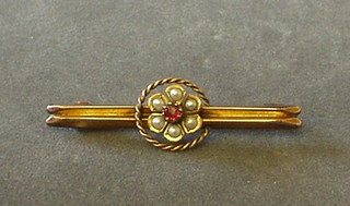 An Edwardian 9ct gold bar brooch set demi-pearls and a garnet