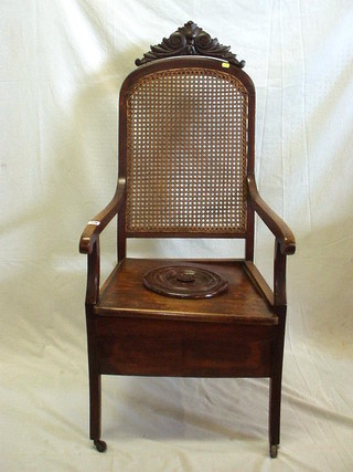 A 19th Century Continental walnutwood commode with arched cresting rail, cane back, on square tapering supports