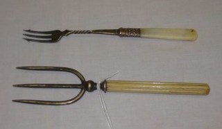A silver plated bread fork with turned ivory handle and a pickle fork with mother of pearl handle