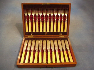 A 12 piece canteen of silver plated fish knives and forks contained in a walnutwood canteen box