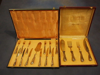 A Continental silver handled 4 piece carving set comprising meat and fish carving knives and a set of 12 Continental silver handled pastry knives and forks with server, cased