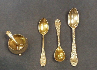 A Tiffany Sterling picture back teaspoon with floral decoration marked patent 1820M, a Tiffany Sterling picture back jam spoon marked 1820M, a "silver" picture back spoon with floral decoration, a silver plated salt spoon and a circular silver plated salt