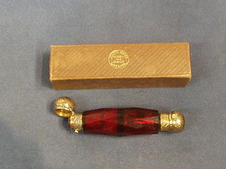 A cranberry glass faceted double ended scent bottle with gilt plated mounts 5" contained in a original presentation box