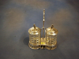 A silver plated and cut glass 2 bottle pickle stand with hobnail cut bottles, contained in a pierced plated mount