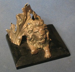 A 19th Century cast "silver" head of a seated lion within laurel leaves, formerly part of a table centre piece 4"