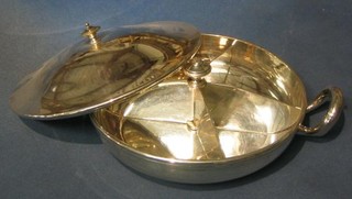 A circular silver plated twin handled entree dish and cover