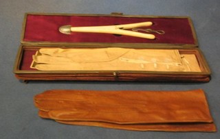 A Victorian leather glove box containing pair of glove stretchers and 2 pairs of gloves
