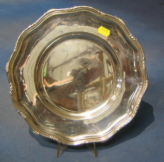 A Continental circular silver plate with cast and bracketed border 11"