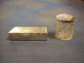 A rectangular silver plated cigarette box with hinged lid 7" and a circular cut glass dressing table jar with embossed silver lid (2)