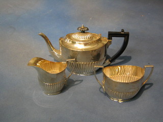 A 3 piece oval silver plated tea service with demi-reeded decoration - teapot, twin handled sugar bowl and cream jug