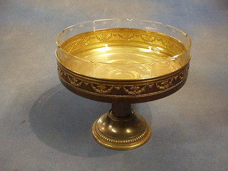 A Continental embossed bronzed metal table centre piece with glass liner 10"