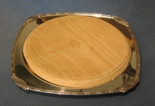 A silver plated bread board holder