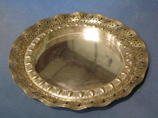 A circular pierced and embossed silver plated bread board holder 11"