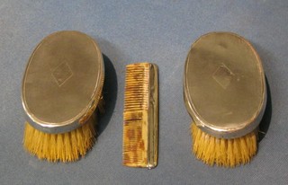 A pair of oval military hair brushes and a comb