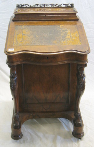 A Victorian figured walnutwood Davenport desk of serpentine outline, the upper section fitted a stationery box with pierced three-quarter gallery, with inset tooled leather writing surface, the pedestal fitted 4 long drawers, raised on cabriole supports 21"