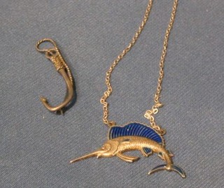 A "silver" brooch in the form of a fishing hook and a "silver" and enamelled pendant in the form of a sword fish hung on a chain