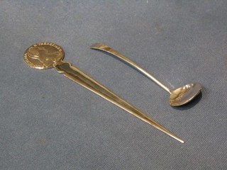 A Continental silver double edged paper knife decorated a Marie Theresa coin together with a small silver Old English pattern sauce ladle