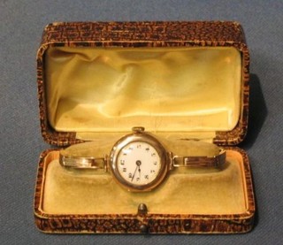 A lady's gold cased wristwatch on an integral gold bracelet