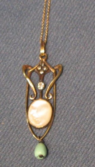 An Art Nouveau 9ct gold pendant set an "opal" surmounted by a diamond and with turquoise drop