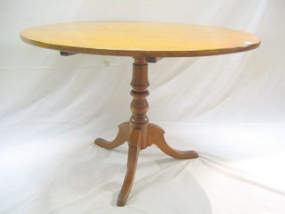 A 19th Century satinwood circular snap top tea table, raised on pillar and tripod supports, 42"