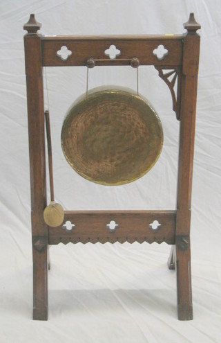 A Victorian honey oak dinner gong stand with brass gong