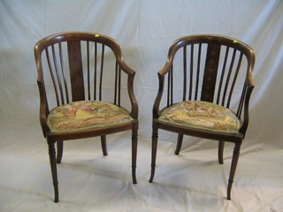 A pair of Edwardian inlaid mahogany stick and tub back chairs with tapestry seats on turned supports 
