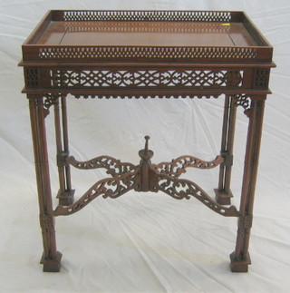A Chippendale style mahogany silver table with pierced gallery, raised on column supports 23"
