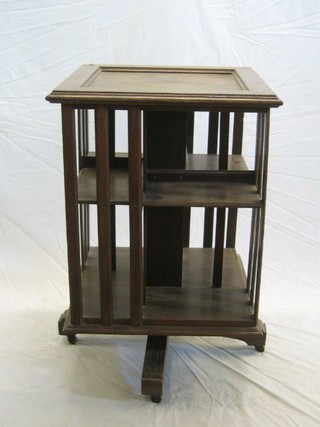 An Edwardian square oak revolving bookcase 23"