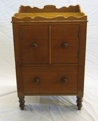 A 19th Century honey oak commode with wavy border fitted a double cupboard and 1 long drawer, raised on bun supports